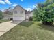 Charming two-story home with two-car garage and a well-manicured front lawn at 277 Players Cir, Fayetteville, GA 30215