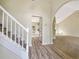 Inviting foyer with wood flooring, staircase, and archway leading to living spaces at 277 Players Cir, Fayetteville, GA 30215