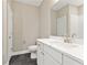 Cozy bathroom with a single sink vanity with a large mirror and tiled backsplash at 5210 Ginger Rose Ct, Cumming, GA 30028