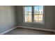 Bright bedroom with large windows, neutral paint, and plush carpet flooring at 5210 Ginger Rose Ct, Cumming, GA 30028