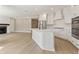 Modern kitchen with white cabinets, stainless steel appliances, and large island with seating at 5210 Ginger Rose Ct, Cumming, GA 30028