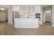 Modern kitchen with stainless steel appliances and large island with sink and stone countertop at 5210 Ginger Rose Ct, Cumming, GA 30028