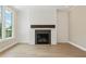 Modern fireplace with white shiplap wall and beautiful hardwood floors in the living room at 5210 Ginger Rose Ct, Cumming, GA 30028