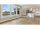 Open concept living area flowing into kitchen with island, with natural lighting from large windows at 5210 Ginger Rose Ct, Cumming, GA 30028