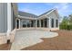 Charming outdoor patio featuring brick pavers and gray siding, perfect for relaxing or entertaining guests at 5210 Ginger Rose Ct, Cumming, GA 30028