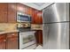 Stainless steel appliances and wood cabinets in galley kitchen at 2870 Pharr Court South Nw # 2407, Atlanta, GA 30305