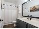 Clean bathroom with a vanity, shower/tub combo, and modern fixtures at 7655 Abbey Glen Dr, Cumming, GA 30028