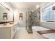 Elegant bathroom with double vanity, large shower, and soaking tub at 7655 Abbey Glen Dr, Cumming, GA 30028