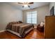 Bedroom with hardwood floors, ceiling fan and window at 7655 Abbey Glen Dr, Cumming, GA 30028