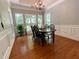 Formal dining room with hardwood floors, chandelier, and large windows at 7655 Abbey Glen Dr, Cumming, GA 30028