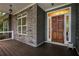 Inviting front porch with stone accents and hardwood flooring at 7655 Abbey Glen Dr, Cumming, GA 30028