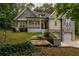 Charming two-story house with stone and siding exterior, a welcoming porch, and a two-car garage at 7655 Abbey Glen Dr, Cumming, GA 30028