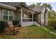Stone and siding house exterior with a covered porch and rocking chair at 7655 Abbey Glen Dr, Cumming, GA 30028