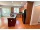 Spacious kitchen with island, stainless steel appliances, and hardwood floors at 7655 Abbey Glen Dr, Cumming, GA 30028