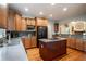 Modern kitchen with wood cabinets, granite countertops, and large island at 7655 Abbey Glen Dr, Cumming, GA 30028