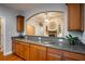Kitchen with breakfast bar, granite countertops, and custom cabinetry at 7655 Abbey Glen Dr, Cumming, GA 30028