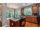 Modern kitchen with island, stainless steel appliances and breakfast nook at 7655 Abbey Glen Dr, Cumming, GA 30028
