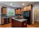 Eat-in kitchen with island, stainless steel appliances, and hardwood floors at 7655 Abbey Glen Dr, Cumming, GA 30028