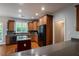 Eat-in kitchen with wood cabinets, granite countertops and stainless steel appliances at 7655 Abbey Glen Dr, Cumming, GA 30028