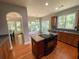 Updated kitchen with island, wood cabinets and views into dining area at 7655 Abbey Glen Dr, Cumming, GA 30028