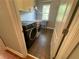 Laundry room with washer, dryer, and built-in cabinets at 7655 Abbey Glen Dr, Cumming, GA 30028