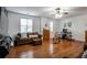 Living area features hardwood floors, comfortable seating, and a home office space at 7655 Abbey Glen Dr, Cumming, GA 30028