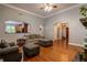 Open living room with hardwood floors and views into kitchen and entryway at 7655 Abbey Glen Dr, Cumming, GA 30028