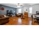 Spacious living room with hardwood floors, a cozy sofa, and entertainment center at 7655 Abbey Glen Dr, Cumming, GA 30028