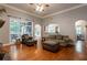 Living room with hardwood floors, stone fireplace and access to backyard at 7655 Abbey Glen Dr, Cumming, GA 30028