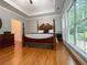 Main bedroom with hardwood floors, large windows, and a ceiling fan at 7655 Abbey Glen Dr, Cumming, GA 30028