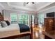 Main bedroom with hardwood floors, large windows, and a ceiling fan at 7655 Abbey Glen Dr, Cumming, GA 30028