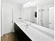 Modern bathroom features a long vanity and shower-tub combo at 55 Cherohala Ct, Covington, GA 30016
