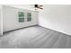 Spacious carpeted bedroom with neutral colors and a ceiling fan at 55 Cherohala Ct, Covington, GA 30016