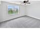 Bright bedroom featuring a ceiling fan, plush carpet and a large window at 55 Cherohala Ct, Covington, GA 30016