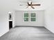 Spacious primary bedroom with natural light and ceiling fan at 55 Cherohala Ct, Covington, GA 30016