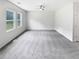 Spacious bedroom with plush carpet, neutral colors, and natural light from large windows at 55 Cherohala Ct, Covington, GA 30016