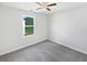 Well-lit bedroom with a ceiling fan and natural light from the window at 55 Cherohala Ct, Covington, GA 30016