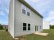 Exterior view of the home showing its neutral siding, large windows, and backyard at 55 Cherohala Ct, Covington, GA 30016