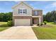 Charming two-story home with a well-manicured lawn and a two-car garage at 55 Cherohala Ct, Covington, GA 30016