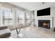 Living room with fireplace, hardwood floors, and large windows at 1456 Ridgebend Way, Mableton, GA 30126