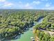 Scenic aerial view showcasing lakefront properties surrounded by lush greenery at 5775 Lakeshore Dr, Buford, GA 30518