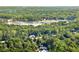 Residential property with mature trees in a waterfront community viewed from above at 5775 Lakeshore Dr, Buford, GA 30518