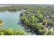 Expansive aerial view of waterfront homes with boat docks surrounded by mature trees at 5775 Lakeshore Dr, Buford, GA 30518