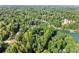 Lush, green, sprawling forest surrounding lakefront homes on a sunny day at 5775 Lakeshore Dr, Buford, GA 30518