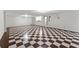 Spacious basement with checkerboard floors, recessed lighting, and a kitchen area at 5775 Lakeshore Dr, Buford, GA 30518