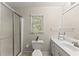 Neutral bathroom with white sink vanity, toilet, and glass shower at 5775 Lakeshore Dr, Buford, GA 30518