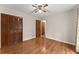 Bedroom features beautiful hardwood floors, closet, and neutral paint at 5775 Lakeshore Dr, Buford, GA 30518