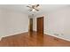 Spacious bedroom with hardwood floors, ceiling fan, and closet, offering ample storage at 5775 Lakeshore Dr, Buford, GA 30518