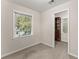 Bedroom featuring a window with blinds and walk-in closet, offering ample storage and natural light at 5775 Lakeshore Dr, Buford, GA 30518