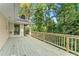 Spacious wooden deck overlooking lush greenery, perfect for outdoor entertaining and relaxation at 5775 Lakeshore Dr, Buford, GA 30518